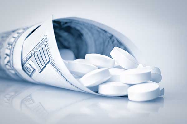 Hundred dollars bill containing white pills
